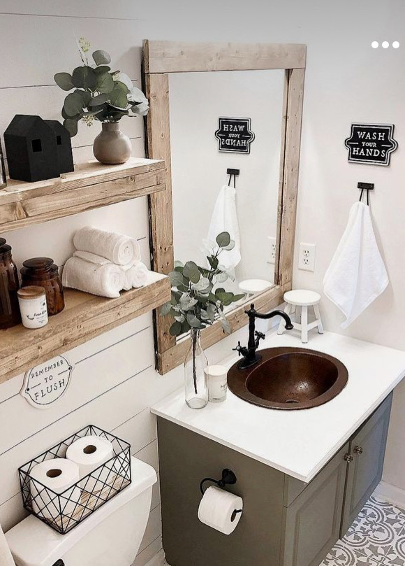 bathroom with white shiplap wall and rustic wood shelves and green vanity