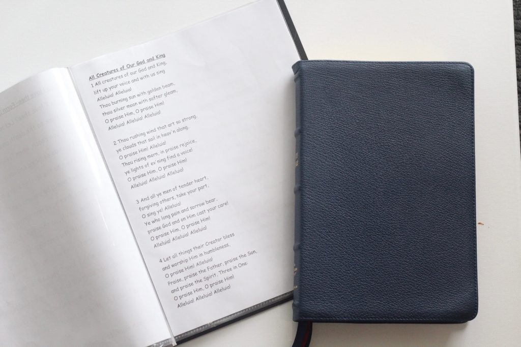 Bible and notebook with songs for singing in family devotions together as a large family.