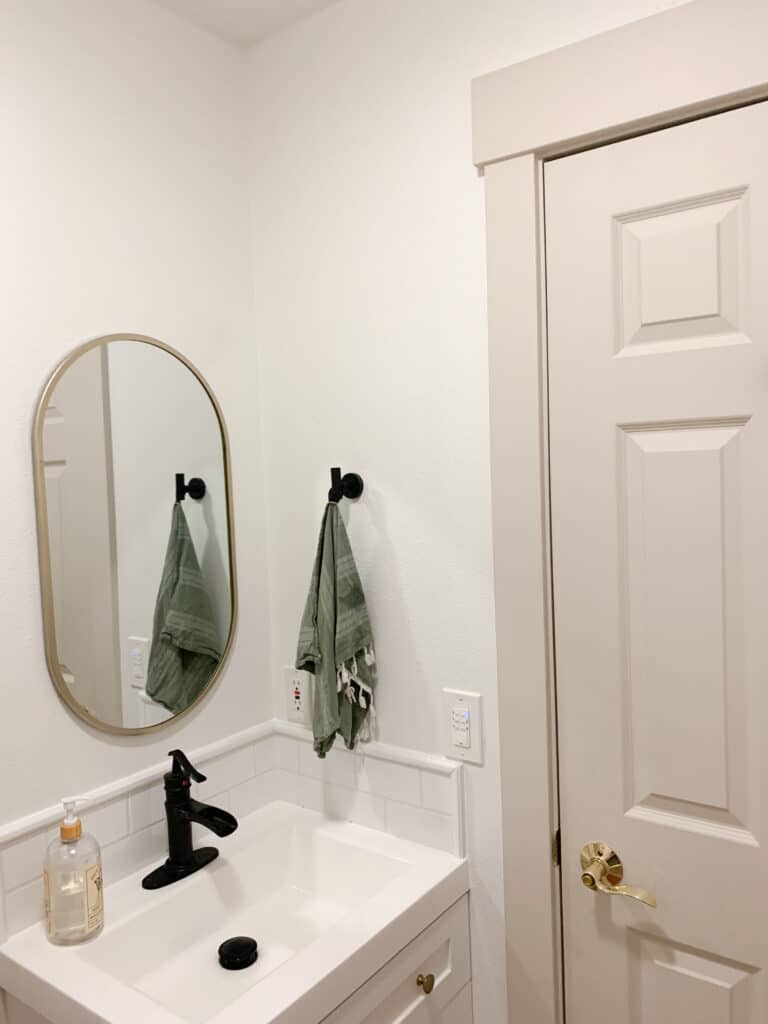 budget bathroom makeover with white subway tile and budget priced vanity and affordable waterfall faucet